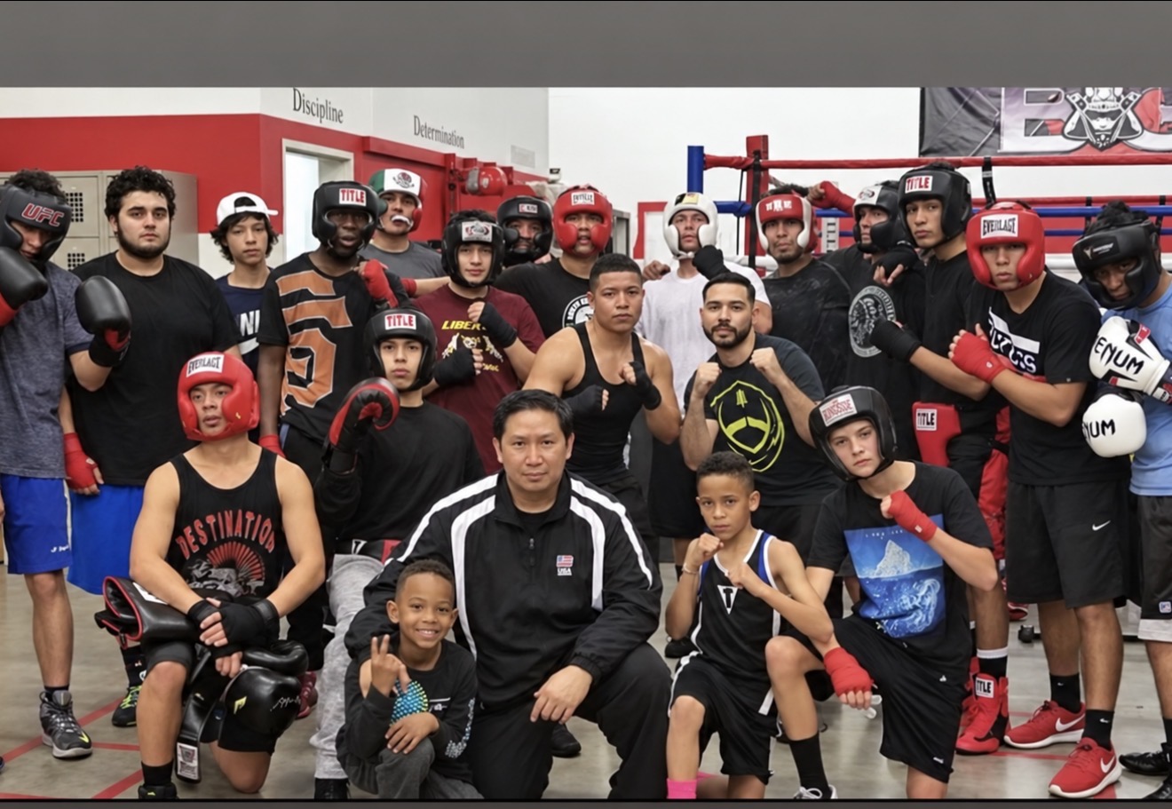 Battlefit Gym kids, teens and coaches together in boxing gear beside the ring